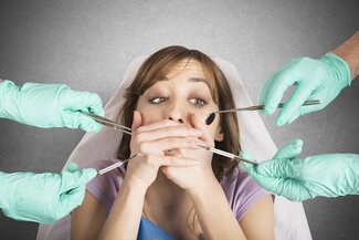 woman afraid of dentist, dentist hands holding tools near her face