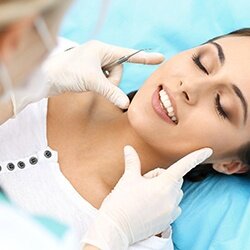 woman with dentist getting dental bonding on teeth